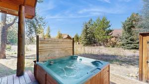 a hot tub on a deck in a yard at Sunset Cabin in McCall