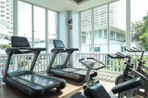 a gym with three exercise bikes in a room with windows at D Varee Jomtien Beach, Pattaya in Jomtien Beach +121 photos