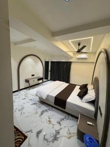 a large bedroom with a large bed in a room at Hotel D Lite Inn in Junagadh