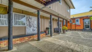 a building with a mural on the side of it at Beachcomber Lodge & Backpacker in Kaitaia