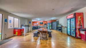 a room with a table and two arcade machines at Beachcomber Lodge & Backpacker in Kaitaia +28 photos