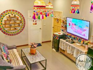 a living room with a tv and a room with a game at Vanilla Sky @Khao Yai in Ban Bung Toei