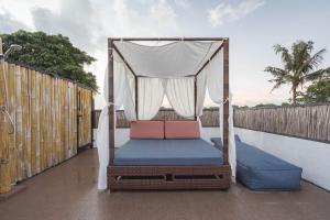 a porch with a canopy bed on a balcony at The Magic Villa in Lebih +91 photos