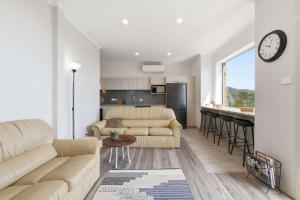 a living room with a couch and a kitchen at MONA Vista, Tasmania in Rosetta
