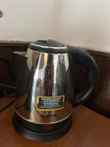 a tea kettle is sitting on a table at Hotel Devidyar in Manāli +123 photos