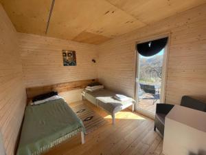 a small room with a bed and a window at B-House in Tyudov