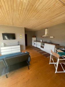 a large living room with a couch and a kitchen at B-House in Tyudov +11 photos