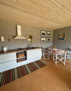 a kitchen with a sink and a table in a room at B-House in Tyudov