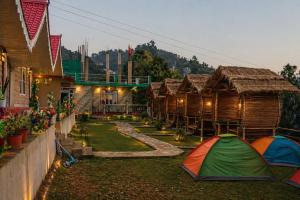 a group of huts with tents in a yard at Aadharjun Homestay in Chidām