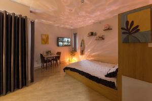 a bedroom with a bed and a table in it at Gấu Studio Ngoại Giao Đoàn in Hanoi
