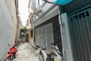 a couple of motorcycles parked next to a building at Gấu Studio Ngoại Giao Đoàn in Hanoi