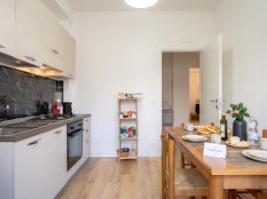 a kitchen with a wooden table and a counter top at Bari Home in Bari