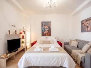 a bedroom with a large bed and a couch at Bari Home in Bari +8 photos