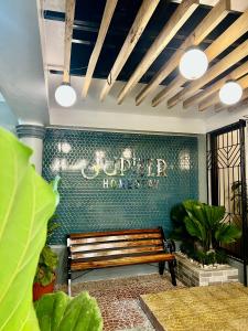 a bench in a room with a sign on a wall at Jupiter Homestay in Cabanatuan