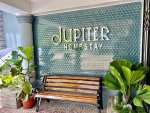 a wooden bench sitting in front of a building at Jupiter Homestay in Cabanatuan