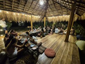 a group of people sitting at tables in a pavilion at Tahini and Friends Surf, Yoga & Wellness in Ahangama