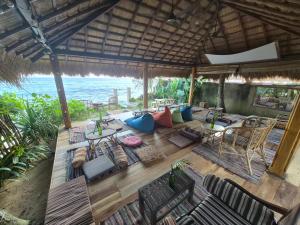 an open living room with a view of the ocean at Tahini and Friends Surf, Yoga & Wellness in Ahangama