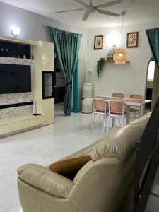 a living room with a couch and a table at wawa homestay in Butterworth