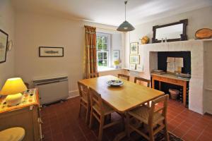 a dining room with a table and a fireplace at 4 Bed in Renvyle oc-i258 in Salrock