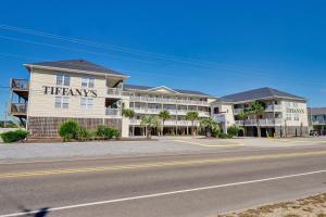 a building with a therapy sign on the side of it at Surf City Stay Motel Unit - Walk to Beach in Surf City
