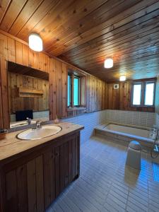 a large bathroom with a sink and a tub at Cabin D 3min walk Lake Saiko remote work BBQ, 5min drive Kawaguchi Lake Mt Fuji view in Narusawa +68 photos