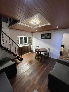 a living room with a table and chairs and a couch at CHILLY CHALET Cabana in Nuwara Eliya