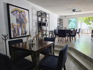 a dining room and living room with a table and chairs at 4 VENATOR House Boutique in León