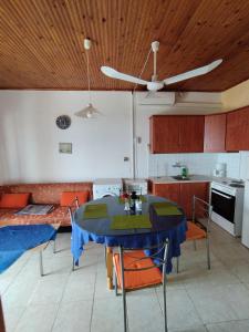 a living room with a table and a couch at Takis Haikos House two minutes walk to the beach Peroulia in Vounaria