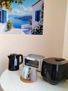 a counter with a toaster and a toaster and a picture of a window at Winston in Chiba
