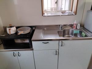 a kitchen with a sink and a counter top at Winston in Chiba +12 photos