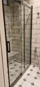 a shower with a glass door in a bathroom at Batumi Sea View in Batumi +36 photos
