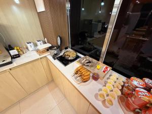 a kitchen with a counter with food on it at Latree Hotel in Seoul