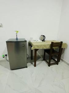 a table and a chair next to a small table and a table and a table at Sigiri Gateway in Galewela
