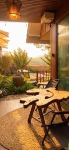 a wooden picnic table and a chair on a patio at Valley homestay Dalat in Da Thien