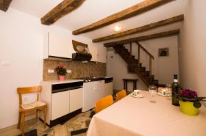 a kitchen and dining room with a table and chairs at Holiday Home Troštova Kuća in Pazin +5 photos