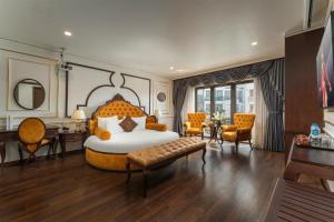 a bedroom with a large bed and a desk and chairs at ORA Hotel in Văn La
