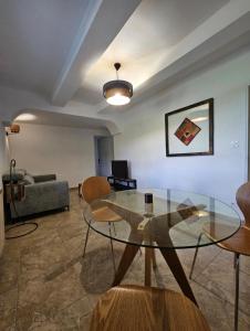 a living room with a glass table and a couch at Ecrin au milieu des vignes in Uchaux