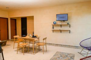 a dining room with a table and chairs at In Wotoch Chicxulub by Casago in Chicxulub