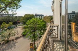 a balcony with a view of a street and trees at ORA Hotel in Văn La