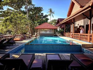 a swimming pool with a gazebo next to a house at Basic Simple Family 3 Bedroom for 4 Person in Nathon Bay