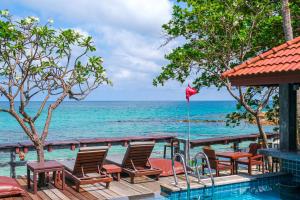 a pool with chairs and a view of the ocean at Basic Simple Family 3 Bedroom for 4 Person in Nathon Bay