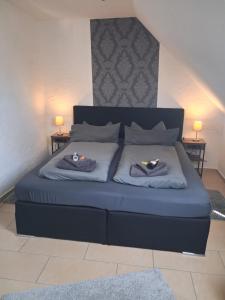 a bedroom with a bed with two towels on it at Haus Morgenstern Fewo Boben in Neuharlingersiel