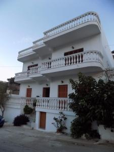 a large white building with a balcony on it at Anesis in Diafani