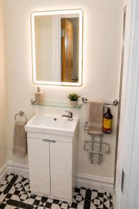 a bathroom with a white sink and a mirror at Unit 1 Island View Apartments - Town Centre Walk To Everything in Cobh