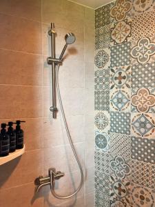 a shower in a bathroom with tiles on the wall at maisonde ojolac in Kosŏng-ni +145 photos