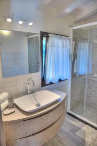 a bathroom with a sink and a shower at La Casa di Pietra in Villa Faraldi