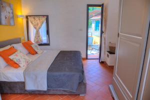 a bedroom with a bed and a door to a patio at La Casa di Pietra in Villa Faraldi