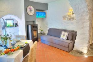 a living room with a couch and a table at La Casa di Pietra in Villa Faraldi