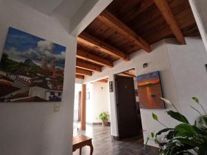 a hallway in a house with a painting on the wall at Hotel San Sebastian in Valle de Bravo +102 photos