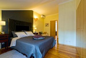 a bedroom with a bed with a blue blanket on it at Apartments in downtown in Lisbon